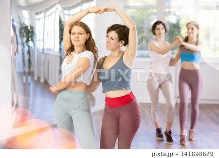 Group of women dancing pair dances in studio Group of women dancing pair dances in studio 141898629
