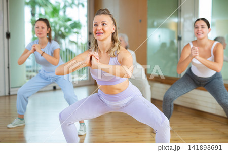 Positive people practicing vigorous lindy hop movements in dance class Positive people practicing vigorous lindy hop movements in dance class 141898691