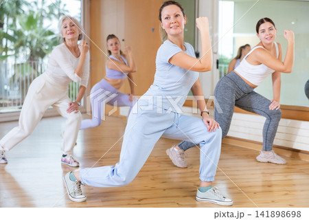 Active people practicing lindy hop movements in dance class 141898698