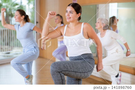 Women dancing aerobics at lesson in dance class Women dancing aerobics at lesson in dance class 141898760