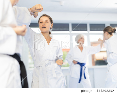 Two women trained to perform basic defensive karate installations and attacking combat techniques Two women trained to perform basic defensive karate installations and attacking combat techniques 141898832