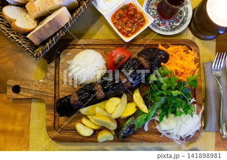 Turkish Patlicanli kebap from eggplant and beef meatballs with garnish Turkish Patlicanli kebap from eggplant and beef meatballs with garnish 141898981