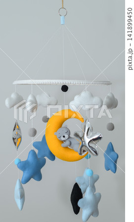 Cute teddy bear sleeping on crescent moon baby crib mobile with clouds and stars 141899450