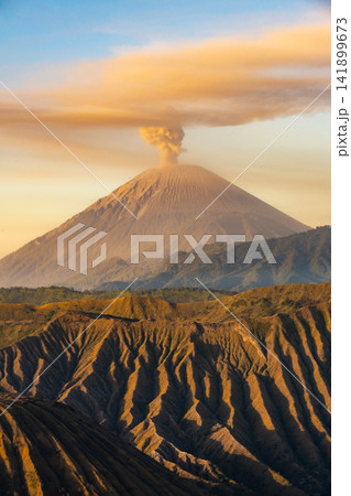 Scenery view of Mount Semeru volcano, Indonesia's highest and most active volcano on Java, frequently emits smoke, ash, and steam plumes. Scenery view of Mount Semeru volcano, Indonesia's highest and most active volcano on Java, frequently emits smoke, ash, and steam plumes. 141899673