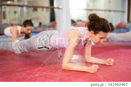 Group of women training abs in gym Group of women training abs in gym 141902467