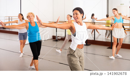 Modern active females dancing excited posing in studio Modern active females dancing excited posing in studio 141902678