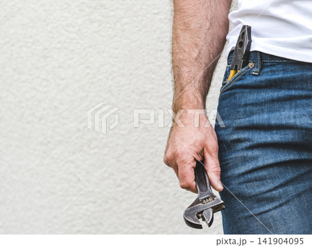 Attractive man, hand tools and work clothes 141904095