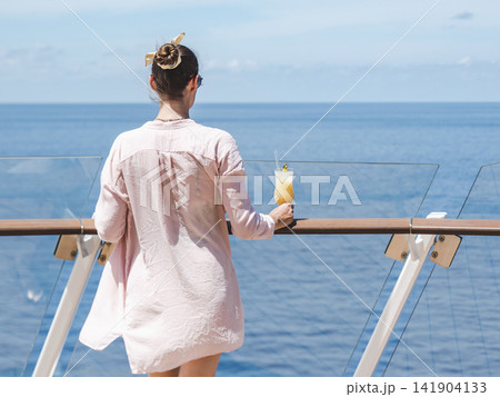 Fashionable woman standing on the empty deck 141904133