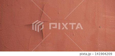 Cracked and peeling red paint on a weathered wall Cracked and peeling red paint on a weathered wall 141904209
