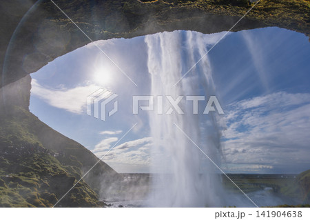 Seljalandsfoss waterfall from behind in Iceland Seljalandsfoss waterfall from behind in Iceland 141904638