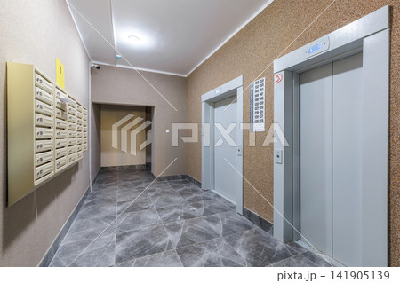 Modern Apartment Building Lobby Interior with Elevators and Mailboxes 141905139