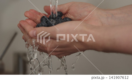man hand wash fresh ripe blueberry man hand wash fresh ripe blueberry 141907612