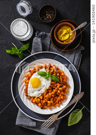 Pan fried cubed potatoes and sausage on plate 141908460