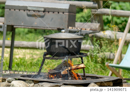 Camping bowler hat hangs over the fire Camping bowler hat hangs over the fire 141909071