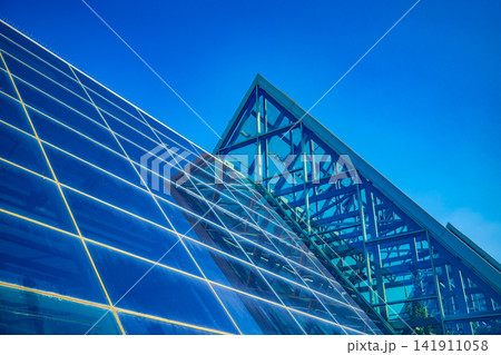 Blue glass greenhouse structure against clear blue sky in Astana Kazakhstan 141911058