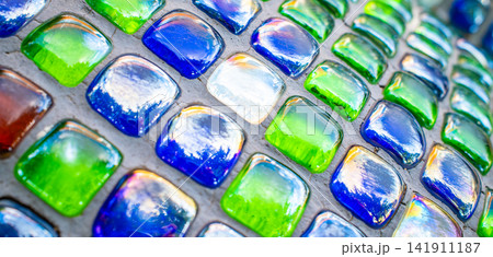 Close up of colorful glass mosaic tile decoration with blue green pattern Close up of colorful glass mosaic tile decoration with blue green pattern 141911187