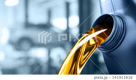 Pouring motor oil into the car engine Pouring motor oil into the car engine 141911616