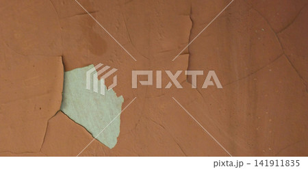 The peeling brown paint reveals a white concrete surface. The peeling brown paint reveals a white concrete surface. 141911835