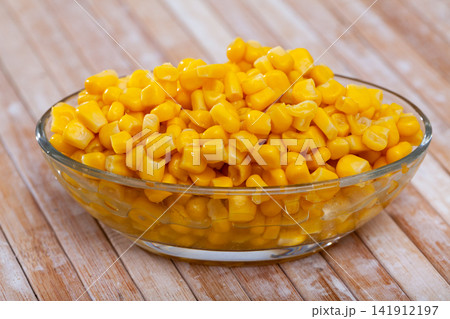 canned corn in bowl on wooden table canned corn in bowl on wooden table 141912197