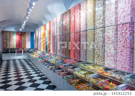 showcase of candy shop, transparent container with various sweets, marshmallow, jelly, chewy gums, rich sugar assortment showcase of candy shop, transparent container with various sweets, marshmallow, jelly, chewy gums, rich sugar assortment 141912253