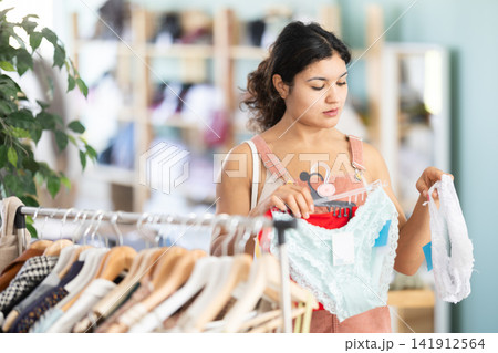Latina chooses panties in a clothing store 141912564