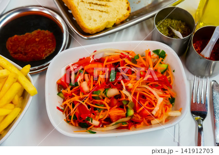 Seasonal vegetable salad with carrot and cucumber Seasonal vegetable salad with carrot and cucumber 141912703