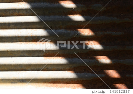 old zinc metal roof background with sunlight, construction industry 141912837