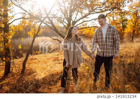 Stylish couple walking and enjoying autumn weather. People, lifestyle, vacations concept. Autumn. Stylish couple walking and enjoying autumn weather. People, lifestyle, vacations concept. Autumn. 141913234