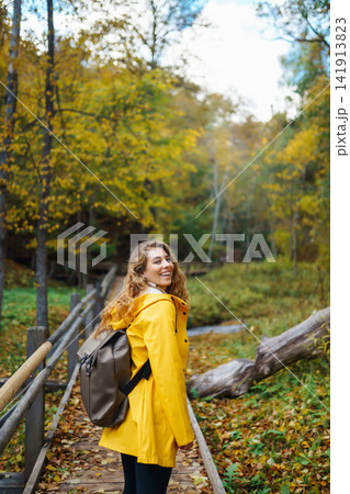 Portrait of young woman walking in the forest. Travelling, lifestyle, adventure. 141913823