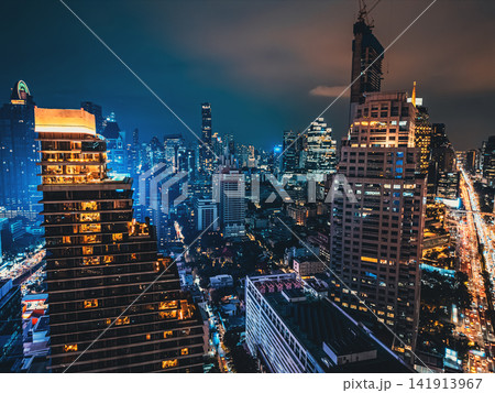 Bangkok city skyline and illuminated high-rise skyscraper buildings, Night cityscape of downtown financial district with modern urban towers of Thailand capital Bangkok city skyline and illuminated high-rise skyscraper buildings, Night cityscape of downtown financial district with modern urban towers of Thailand capital 141913967