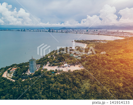 religious Lady Buddha monument at Linh Ung pagoda and buddhism temple in Danang, Asian religion and spirituality, Son Tra peninsula, Da Nang Vietnam, aerial drone view religious Lady Buddha monument at Linh Ung pagoda and buddhism temple in Danang, Asian religion and spirituality, Son Tra peninsula, Da Nang Vietnam, aerial drone view 141914133