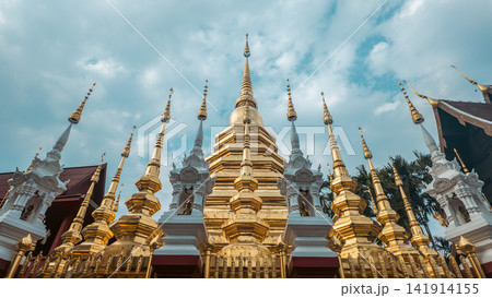 Golden Buddhist temple with ornate pagoda and spires in Chiang Mai, Traditional Thai shrine architecture with gilded stupa and cultural landmark 141914155