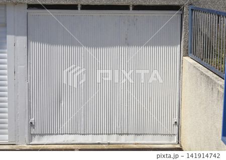 White corrugated metal garage door with vertical lines White corrugated metal garage door with vertical lines 141914742
