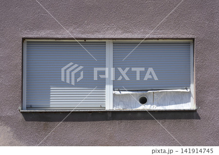 Closed window roller shutters with portable air conditioner vent hole 141914745