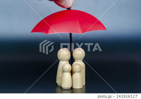 Minimalist family figures sheltered under a red umbrella representing safety, leadership and financial security 141916127