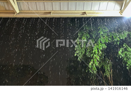 Rain Bomb Intensity: Flash Flooding Rainwater Cascading from Single-Story Home Roof During Extreme Climate Change Downpour. Rain Bomb Intensity: Flash Flooding Rainwater Cascading from Single-Story Home Roof During Extreme Climate Change Downpour. 141916146