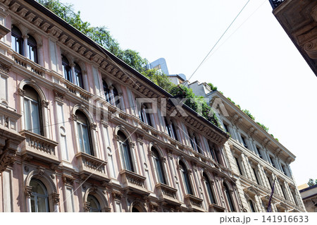 Historic Architecture Facade with Arched Windows and Rooftop Garden in Milan Center City Italy 141916633