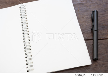 white paper empty book mockup with pen on wood table 141917040