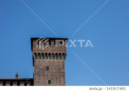 Tower of Sforza Castle Brick Facade against Blue Sky in Milan City Center Italy Tower of Sforza Castle Brick Facade against Blue Sky in Milan City Center Italy 141917465