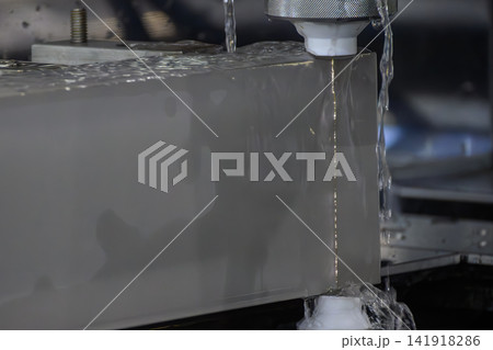 Close up view of wire EDM machine cutting high thickness metal material Close up view of wire EDM machine cutting high thickness metal material 141918286