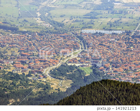 Bansko Bulgaria high angle view of mountain resort town with red tile roofs and Glazne river Bansko Bulgaria high angle view of mountain resort town with red tile roofs and Glazne river 141921213