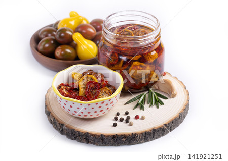 Dried tomatoes with spices in olive oil in a jar, isolated. Dried tomatoes with spices in olive oil in a jar, isolated. 141921251