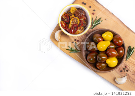Dried tomatoes with spices in olive oil in a jar, isolated. Dried tomatoes with spices in olive oil in a jar, isolated. 141921252