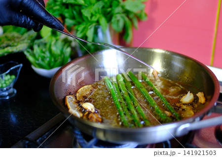 asparagus beans recipe asparagus garlic butter cooked on stainless steel skillet in modern kitchen healthy gourmet meal preparation salmon recipe, healthy, cooking process, restaurant style meal asparagus beans recipe asparagus garlic butter cooked on stainless steel skillet in modern kitchen healthy gourmet meal preparation salmon recipe, healthy, cooking process, restaurant style meal 141921503