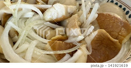 white mushrooms with onions in spotted plate on rustic table food scene white mushrooms with onions in spotted plate on rustic table food scene 141921619