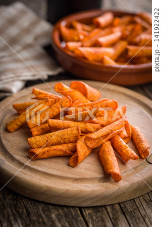 Spicy Rolled Tortilla Chips Piled in a Glass Bowl Crispy Snack Food Closeup Spicy Rolled Tortilla Chips Piled in a Glass Bowl Crispy Snack Food Closeup 141922422