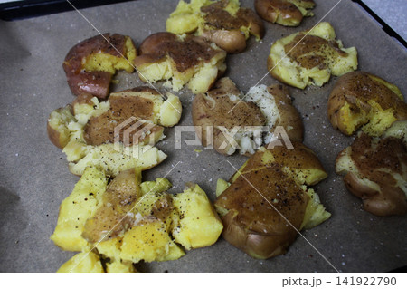crispy baked potatoes on a baking sheet top view. crispy baked potatoes on a baking sheet top view. 141922790