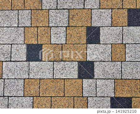 Paving Slabs Pattern Background with Yellow White and Dark Grey Cobblestones 141925210