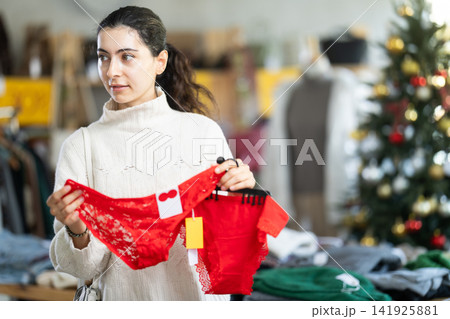 Armenian woman choosing red panties for the new year and Christmas in the store 141925881