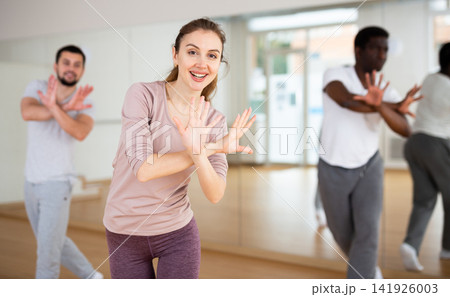 Young woman learning dynamic dances in choreography class Young woman learning dynamic dances in choreography class 141926003